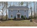 Inviting home featuring a well-manicured lawn and garden beds enhancing the property's curb appeal at 710 Melanie Ct, Canton, GA 30115