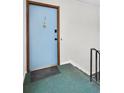 Apartment entryway featuring a light blue door and hallway stairs at 3825 Lavista Rd # Q3, Tucker, GA 30084