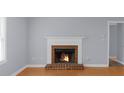 Living room featuring a brick fireplace, hardwood floors, and freshly painted walls at 747 Houston Mill Ne Rd # 1, Atlanta, GA 30329