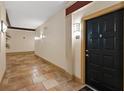 Hallway leads to a unit door, and a tiled floor extends into the distance at 10 Perimeter Summit Ne Blvd # 2112, Atlanta, GA 30319