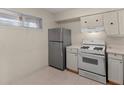 This galley kitchen features white cabinets, appliances, and a window with natural light at 2029 Oak Park Ln, Decatur, GA 30032