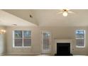 Bright living room featuring a fireplace, neutral walls, and large windows offering natural light at 40 Zebulon Pl, Covington, GA 30016