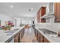 Bright kitchen featuring granite countertops, stainless steel appliances, and an open layout to the living area at 163 Lorraine Pkwy, Woodstock, GA 30188