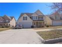 Charming two-story home features a two-car garage, white siding, blue shutters, and manicured landscaping at 4047 Round Stone Trl, Snellville, GA 30039