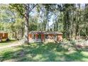 Cozy brick home surrounded by mature trees, offering a private and serene setting at 4479 Richard Rd, Conley, GA 30288