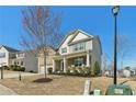 Lovely two-story home with a brick and siding exterior, cozy front porch, and landscaped front yard at 6350 Boulder Rdg, Cumming, GA 30028