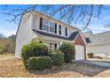 Well-maintained two-story home with vinyl siding and manicured landscaping at 7013 Mahonia Pl, Lithonia, GA 30038