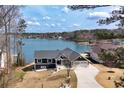 Stunning waterfront home boasting a well-manicured lawn and private access to the serene lake at 2387 Battle Dr, Villa Rica, GA 30180