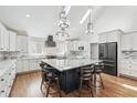 Bright kitchen featuring granite countertops, modern stainless-steel appliances, and a large center island with seating at 2387 Battle Dr, Villa Rica, GA 30180