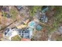 Aerial view of the property, showcasing the pool, home, and surrounding buildings at 300 Mill Creek Ct, Acworth, GA 30101