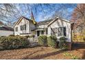 Well-maintained home featuring trimmed hedges, a covered entryway, and a fenced yard at 2033 Old Newnan Rd, Carrollton, GA 30116