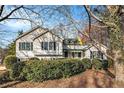 Inviting home exterior with lush landscaping and a quaint covered front porch at 2033 Old Newnan Rd, Carrollton, GA 30116