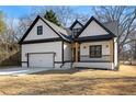 Charming new construction home with a covered porch, craftsman details, and an attached garage at 4374 Westside Nw Dr, Acworth, GA 30101