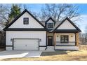 New craftsman-style home with black trim, a covered porch, and an attached garage at 4374 Westside Nw Dr, Acworth, GA 30101