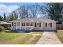 Single-story home featuring a cozy front porch, well-maintained lawn, and concrete driveway at 2753 Wedgewood Ter, Decatur, GA 30032