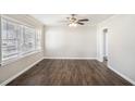 Bright living room featuring durable dark hardwood flooring, large windows, and a ceiling fan at 2753 Wedgewood Ter, Decatur, GA 30032