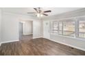 Cozy living room with new hardwood floors, ceiling fan, and a view into the dining room at 2753 Wedgewood Ter, Decatur, GA 30032