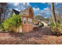 The side of this brick and siding home showcases nice landscaping and a covered front porch at 424 Cannonball Ct, Stockbridge, GA 30281
