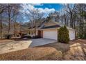 Side view of house showcasing the driveway, well-manicured lawn, and attached two-car garage at 424 Cannonball Ct, Stockbridge, GA 30281