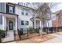 Stylish townhome featuring brick and gray siding, black shutters, and a manicured front yard at 2740 Bell Se Dr, Smyrna, GA 30080