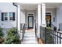 Inviting front porch with white columns, a black front door, and decorative wreath at 2740 Bell Se Dr, Smyrna, GA 30080