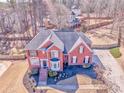 A beautiful two-story home featuring a well-manicured front yard and mature trees at 4213 Bretdale Nw Run, Kennesaw, GA 30152