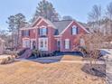 Beautiful two-story home with red brick exterior, detailed landscaping, and a welcoming front yard at 4213 Bretdale Nw Run, Kennesaw, GA 30152