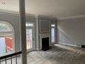 Spacious living room with a fireplace, neutral paint, carpet, and multiple doors leading to the outdoor deck at 871 Embassy Ne Ct, Atlanta, GA 30324