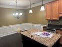 Open kitchen featuring granite counters, stainless steel appliances, and a decorative chandelier at 2530 Gold Creek Ln # 100, Cumming, GA 30041