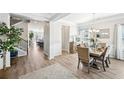Elegant dining room featuring modern decor, hardwood floors, and plenty of natural light at 3510 Meadow Grass Dr, Dacula, GA 30019