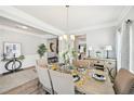 Bright dining room with stylish furnishings, hardwood floors, and a view of the kitchen at 3510 Meadow Grass Dr, Dacula, GA 30019