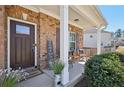 Inviting front porch with comfortable seating, decorative accents, and a welcoming entrance to the home at 3510 Meadow Grass Dr, Dacula, GA 30019