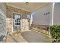 Inviting patio with brick accents and wooden railing perfect for outdoor relaxation and entertaining at 1340 Aster Ives Dr, Lawrenceville, GA 30045