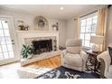 Bright living room featuring a cozy fireplace, wood floors, and neutral decor at 1376 Highway 138 E, Stockbridge, GA 30281