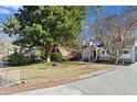 This home boasts manicured front lawn and mature trees for a welcoming, idyllic curb appeal at 351 Delmont Ne Dr, Atlanta, GA 30305