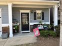 Inviting front porch with decorative plants, a 'Welcome' sign, and seating, creating a cozy entrance at 801 Rutledge Ct, Woodstock, GA 30188