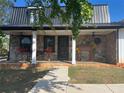 Charming front porch with stone facade, white columns, and decorative accents at 85 Carroll Slough Rd, Kingston, GA 30145