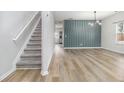 Modern home interior showcasing wood floors, stylish accent wall, and contemporary lighting fixtures at 2011 Farm Hill Ct, Stockbridge, GA 30281