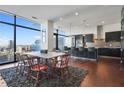 Open dining room with seating for eight, adjacent to a modern kitchen and floor-to-ceiling windows at 45 Ivan Allen Jr Nw Blvd # 1706, Atlanta, GA 30308