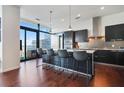 Sleek modern kitchen featuring a large island with seating and city views from the expansive windows at 45 Ivan Allen Jr Nw Blvd # 1706, Atlanta, GA 30308
