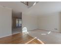Spacious, light-filled living room with neutral carpet, hardwood flooring, and views to the back deck at 5594 Mountain View Pass, Stone Mountain, GA 30087