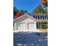 Traditional two-story home featuring a two-car garage and a well-manicured lawn at 10221 Deep Creek Pl, Union City, GA 30291