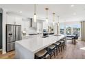 Spacious open-concept kitchen with a large island, stainless steel appliances, and modern pendant lighting at 1115 Rivard Nw Cir, Atlanta, GA 30318