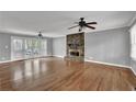 Spacious living room with hardwood floors, stone fireplace, and access to outdoor deck at 3430 Pate Rd, Snellville, GA 30078