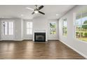 Bright living room featuring hardwood floors, fireplace, and ceiling fan at 7 Hydrangea Unit 70 Way, Auburn, GA 30011