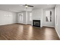Bright living room featuring hardwood floors, fireplace, and ceiling fan at 7 Hydrangea Unit 70 Way, Auburn, GA 30011