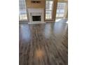 Bright living room with fireplace, offering a cozy space for relaxation and entertainment with luxury vinyl flooring at 10 Chapman Way, Covington, GA 30016