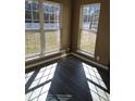 Bright room with large windows providing ample natural light, showcasing the newly installed luxury vinyl flooring at 10 Chapman Way, Covington, GA 30016
