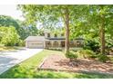 Charming two-story home with a landscaped front yard, two-car garage, and inviting front porch at 2647 Wood Hollow Dr, Dunwoody, GA 30360