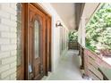 Close-up of an elegant, dark wood front door with decorative glass and stylish sconces at 2647 Wood Hollow Dr, Dunwoody, GA 30360